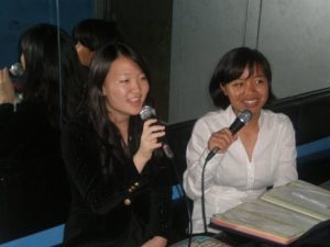 Two debaters sing to karoke on the last night of the workshop. Photo by Alap Patel.