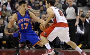 Knicks guard Jeremy Lin defends Raptors quard Jose Calderdon. Lin's rise from bench player to NBA superstar in a matter of weeks has fueled a media craze. Photo from JewishJournal.com.