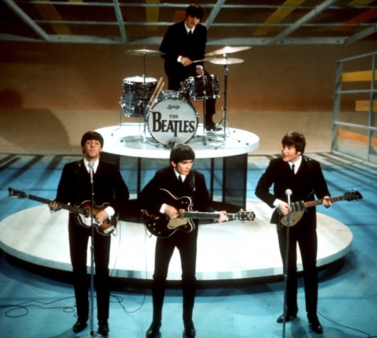 The Beatles perform on the CBS "Ed Sullivan Show" in New York Feb. 9, 1964. From left, front, are Paul McCartney, George Harrison and John Lennon. Ringo Starr plays drums. (AP Photo)