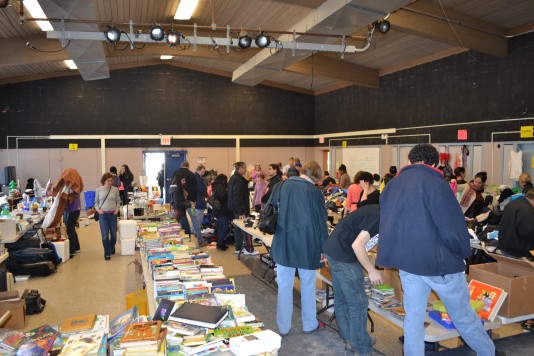 Students, parents and community members rummage through the array of books, clothes and other items at this year's second annual yard sale. The "Give Us Your Stuff" club hosted the sale, which benefitted the Leukemia & Lymphoma Society. Photo by Rebecca Katz.