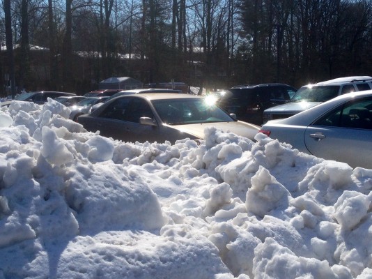 The parking lot was jam packed this morning, as gigantic snow piles prohibited drivers from parking in their usual spots. The mayhem caused many students to be late to first period or park sideways this morning. Photo by Abby Cutler.