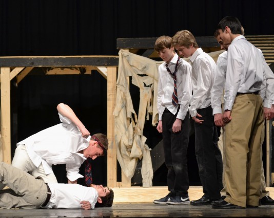 Jordan Wolff (Roger) throws a punch at Jake Zeisel (Simon) in this past weekend's production of "Lord of the Flies." Both the boys' and girls' versions of the show were extremely violent and provocative, which both impressed and creeped out audience members. Photo by Michelle Jarcho. 