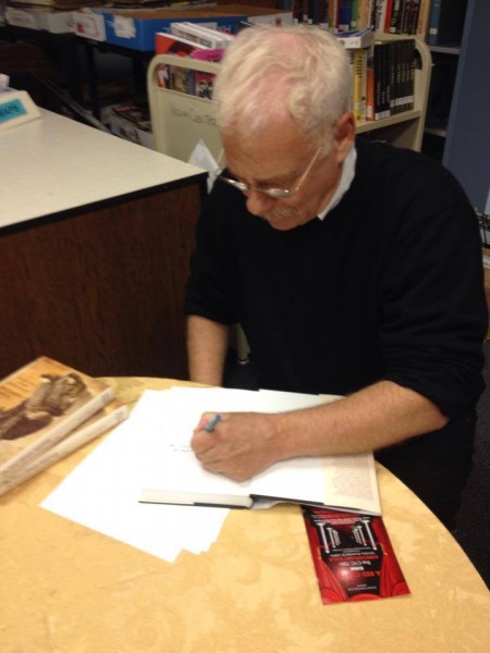 Scott Seligman signs copies of "The First Chinese American" in the Media Center. Photo courtesy Whitworld.
