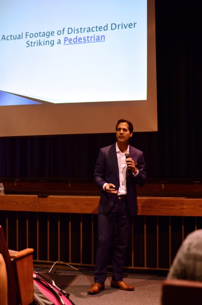 Parent Salvatore Zambri shares a video of a real collision between a car and pedestrian. Zambri warned students of the dangers of phone-use while driving during his hour-long presentation. Photo by Nick Anderson.