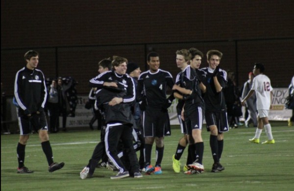 The boys soccer team celebrates following their 4-0 defeat over Bladensburg, securing a spot in the state finals. Photo by Jonah Rosen.