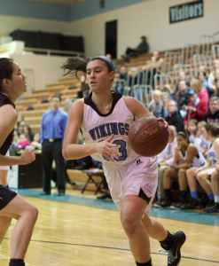 Forward and senior captain Alison Poffley drives to the hoop to score two of her six points in the Viking's win over RM. Photo by Nick Anderson.