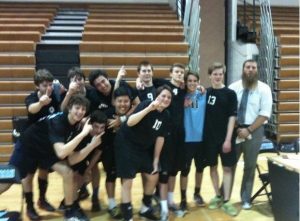The boys volleyball team celebrates their first win in over three years. Photo by Carolyn Price. 