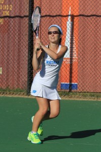 Number one singles player Miranda Tompkins finishes a strong backhand as she overpowers her opponent 6–0, 6–0. Photo courtesy Catherine Matthews.