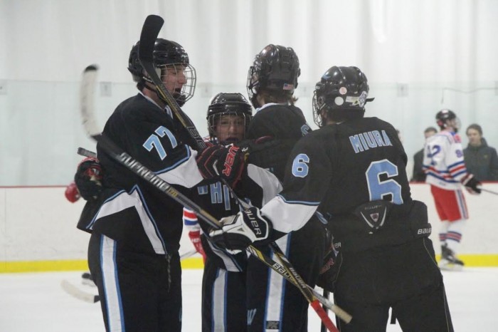 The Vikes surround forward Tyler Crist after his first of two goals. Photo courtesy Tammy Hughes.