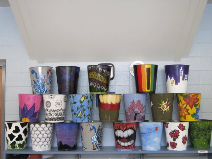 Art students designed trash cans to put on display in the media center. Art teacher Jean Diamond hopes that every classroom will have a one of these colorful trash cans eventually. Photo by Allie Lerner.