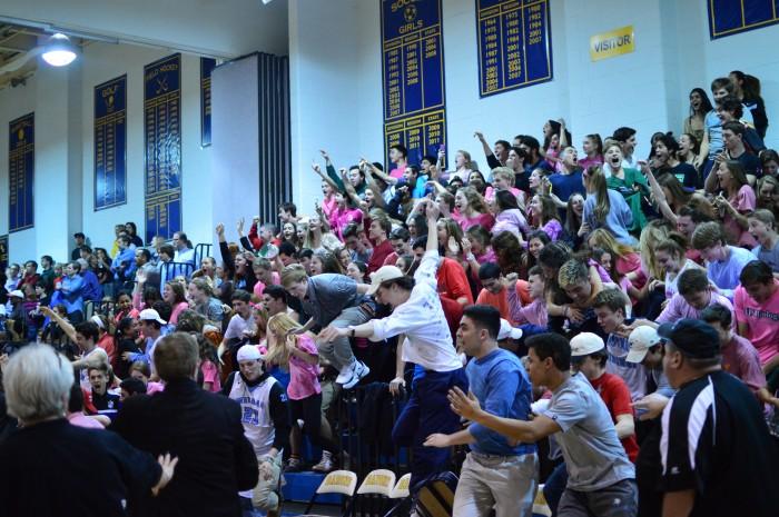 Whitman fans storm the court after the last second victory. Photo by Tomas Castro.