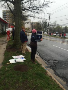 Protesters, undeterred by rain and cold weather, chanted and waved signs in support of the petition against the new Westbard development plans. Photo by Anna Grey