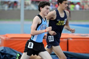 Distance runner Josh Engels looks to pass a B-CC runner in the 3200 race. Photo courtesy Moco Running.