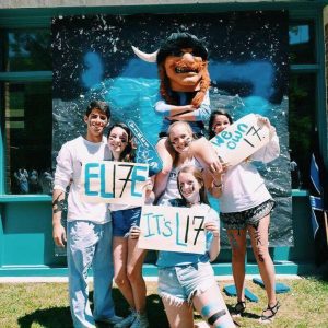 Rising seniors take pictures with the Whitman Viking, holding signs with class slogans like "We own it." Photo courtesy Grace Goldman.