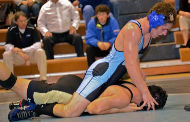 180 lb. wrestler Brad Taylor dominates his opponent during the wrestling team's 52-21 win over the Poolesville Falcons. Photo by Abby Cutler.