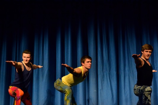 Seniors Jeff Marr, Harrison Holt and Grant Payette (left to right) perform yoga poses while scantily clad in tight pants and sleeveless shirts. The three seniors earned $750 for the Leukemia & Lymphoma Society for a date to hot yoga and lunch. Photo by Abby Cutler.