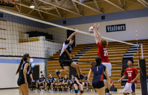 Outside hitter Riley Shaver goes up for a spike against the Patriots. Photo courtesy Chris Hanessian.  