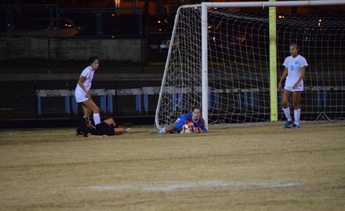 Goalie Katie Stender-Moore grabs the ball after a save during the first half of Tuesday's loss to WJ. Photo by Rachel Hazan.