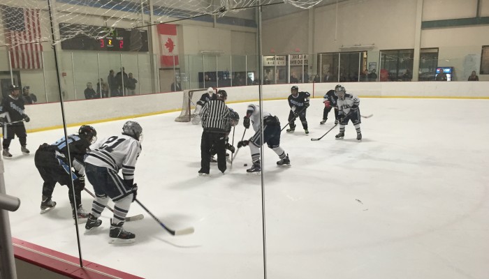 The Vikings fight to move the puck away from their goal after a faceoff during the second period. Photo by Carolyn Price.