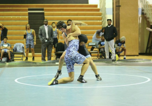 Returning senior Ezra Alexander pins a Digital Harbor opponent in a victory last season. Photo by Michelle Jarcho.